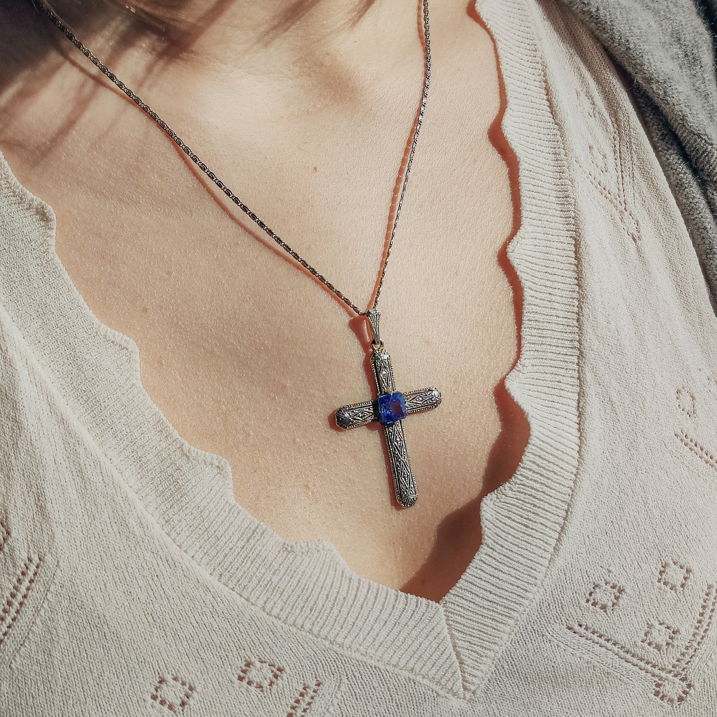 Art Deco Cross Pendant with Blue Spinel around neck