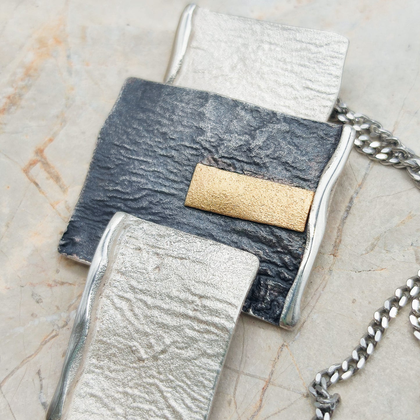 Handmade pendant by Audar in silver with 24K gold details