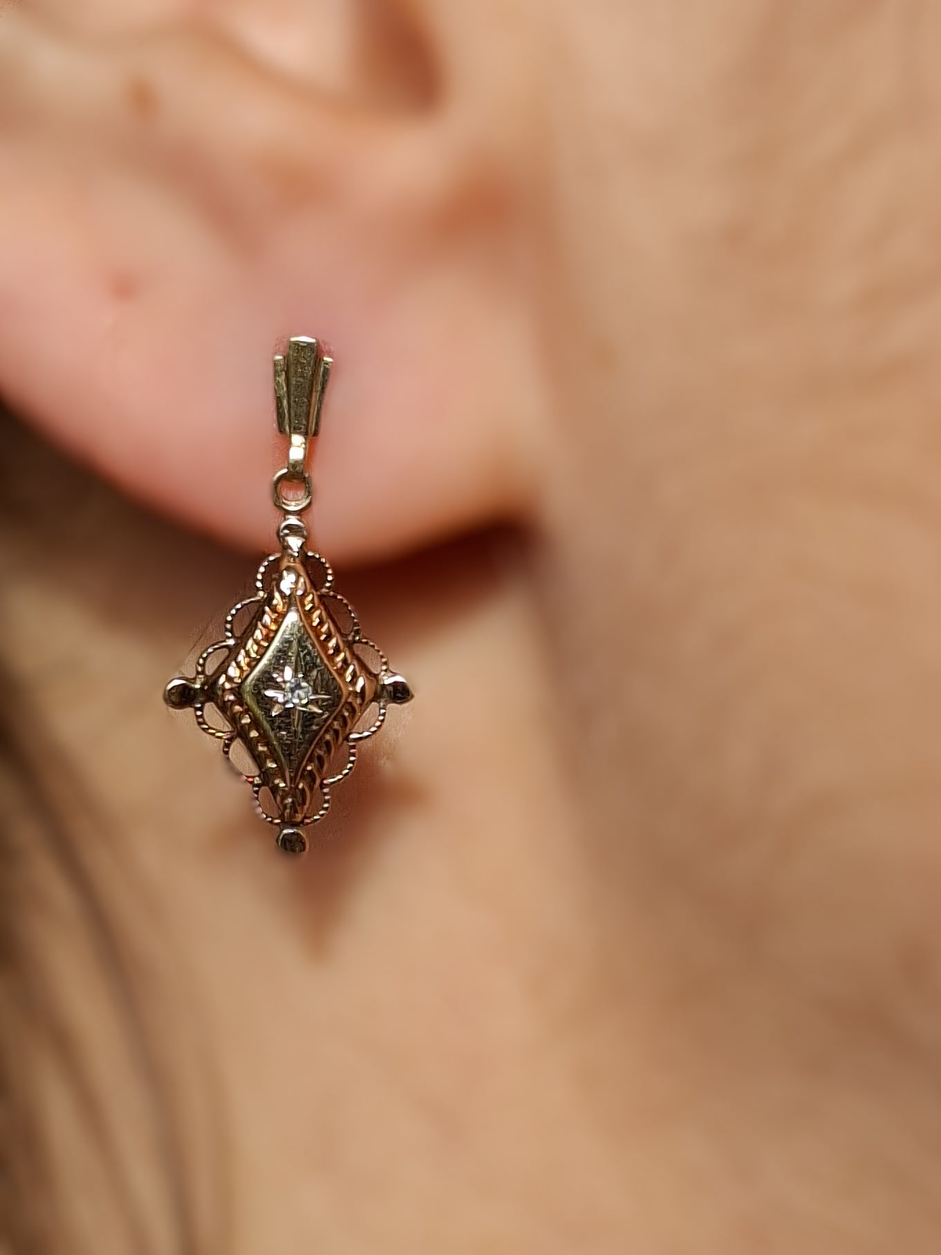Antique gold diamond earrings worn in ear, circa 1900