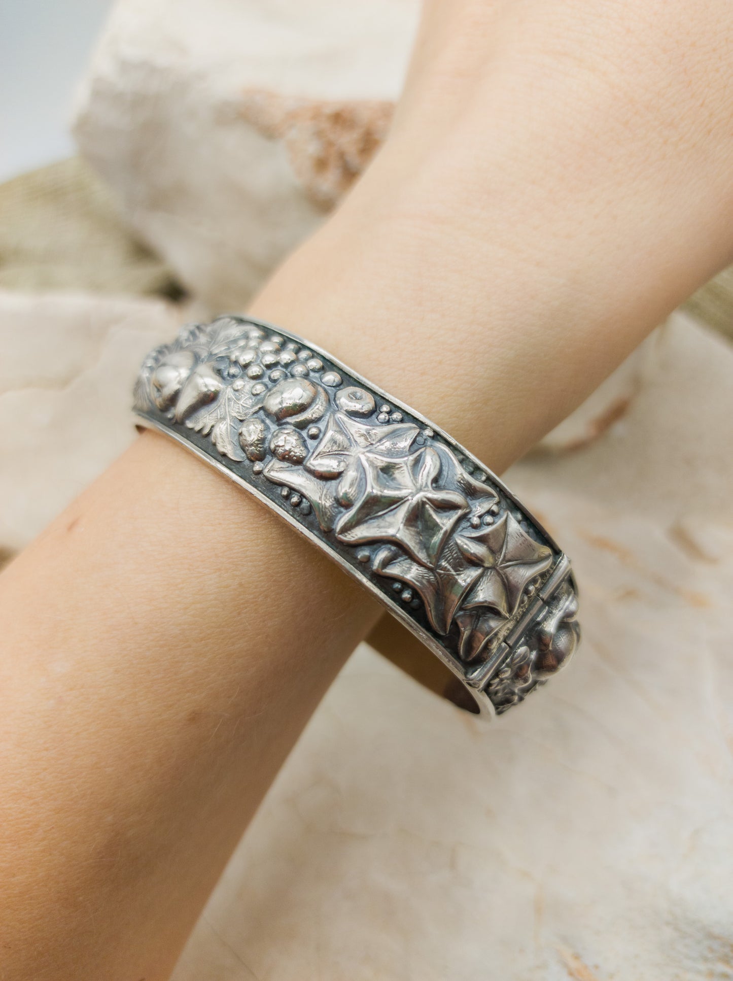 Vintage portugese silver repoussé bracelet with harvest theme on arm, leaf detail