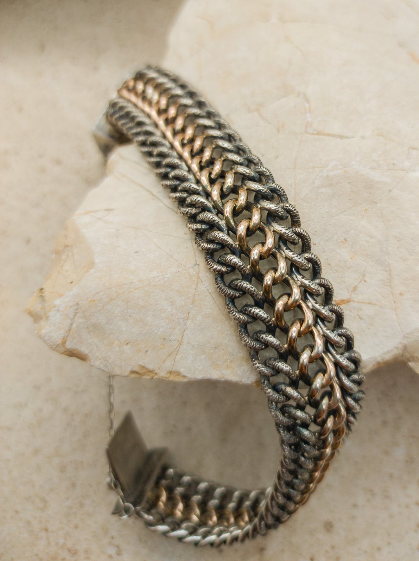 Victorian Silver repoussé chain bracelet with box clasp and rose gold plated details. detailed view of the links