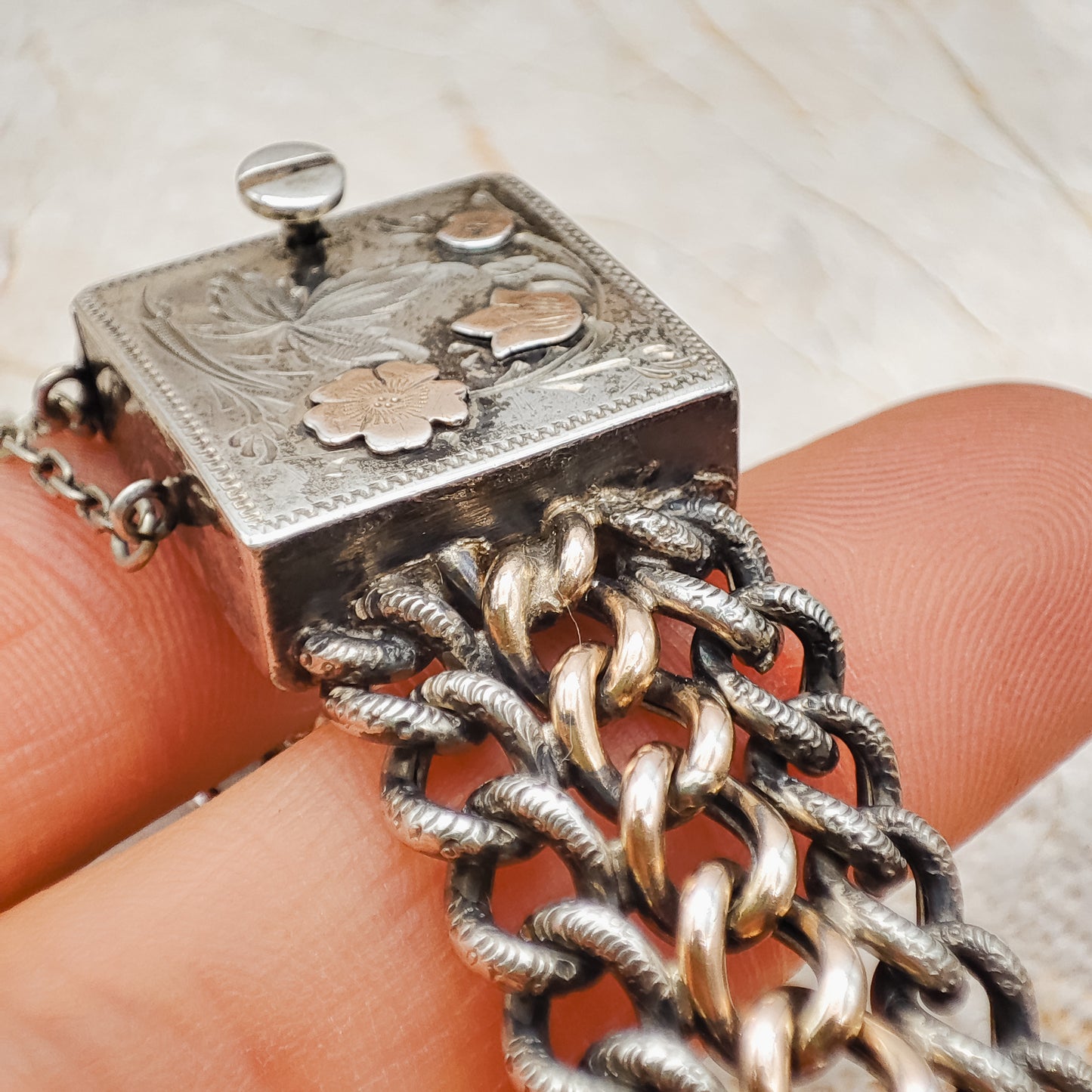 Victorian Silver repoussé chain bracelet with box clasp and rose gold plated details, detailed view of the side