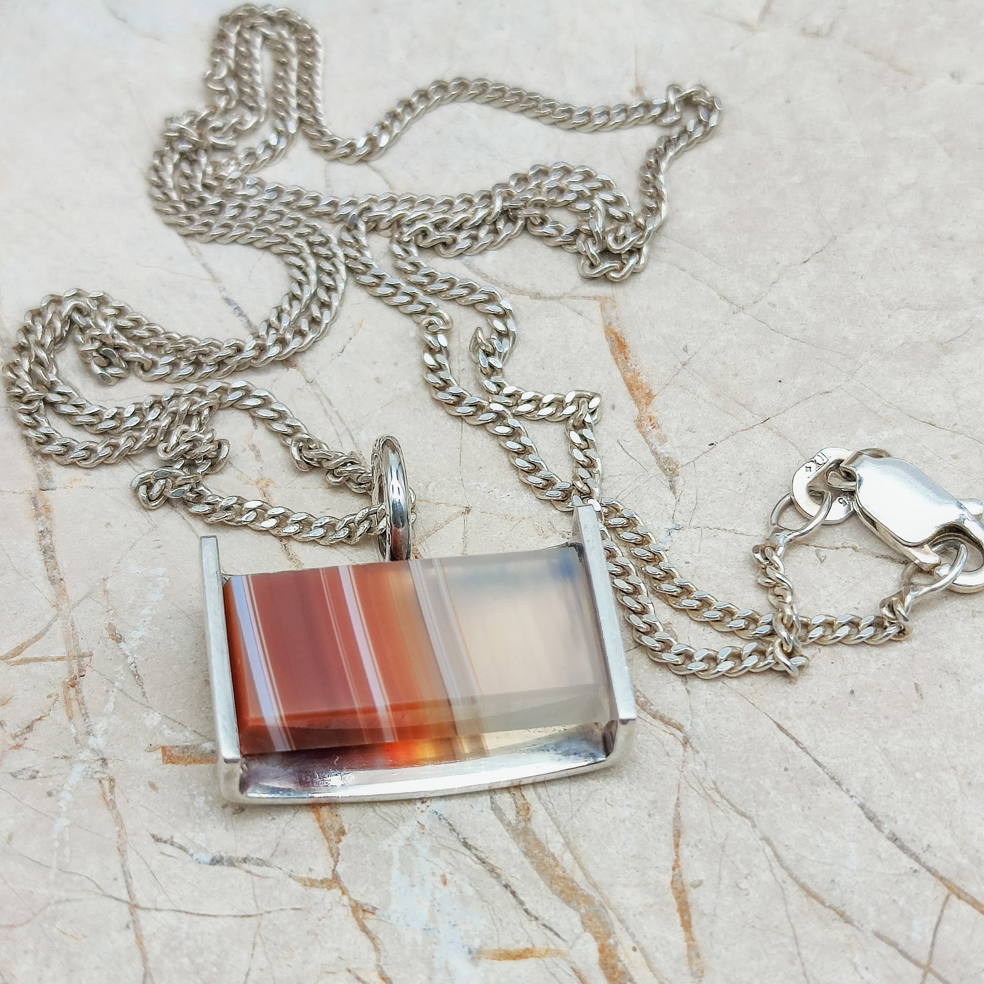 Striped Agate by Elis Kauppi for Kupittaan Kulta with necklace