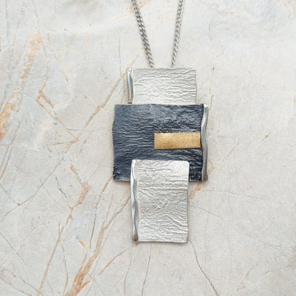Handmade pendant by Audar in silver with 24K gold details
