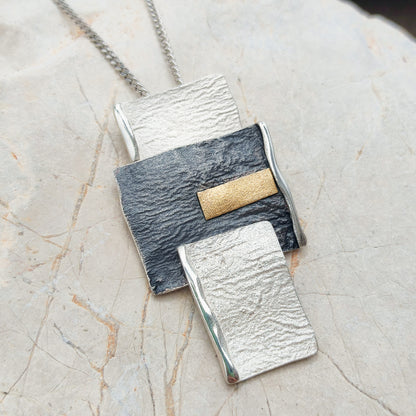 Handmade pendant by Audar in silver with 24K gold details