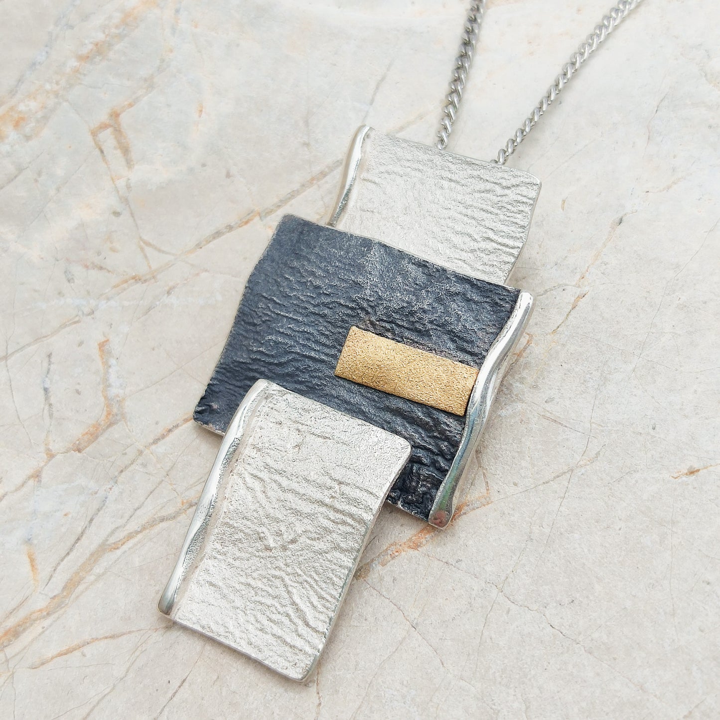 Handmade pendant by Audar in silver with 24K gold details