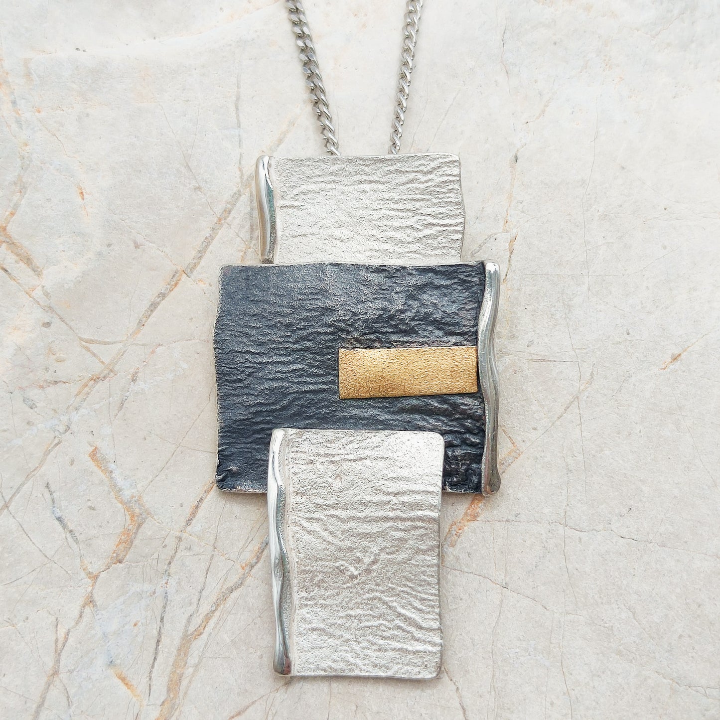 Handmade pendant by Audar in silver with 24K gold details