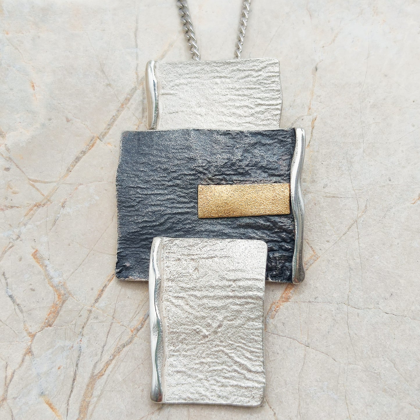 Handmade pendant by Audar in silver with 24K gold details