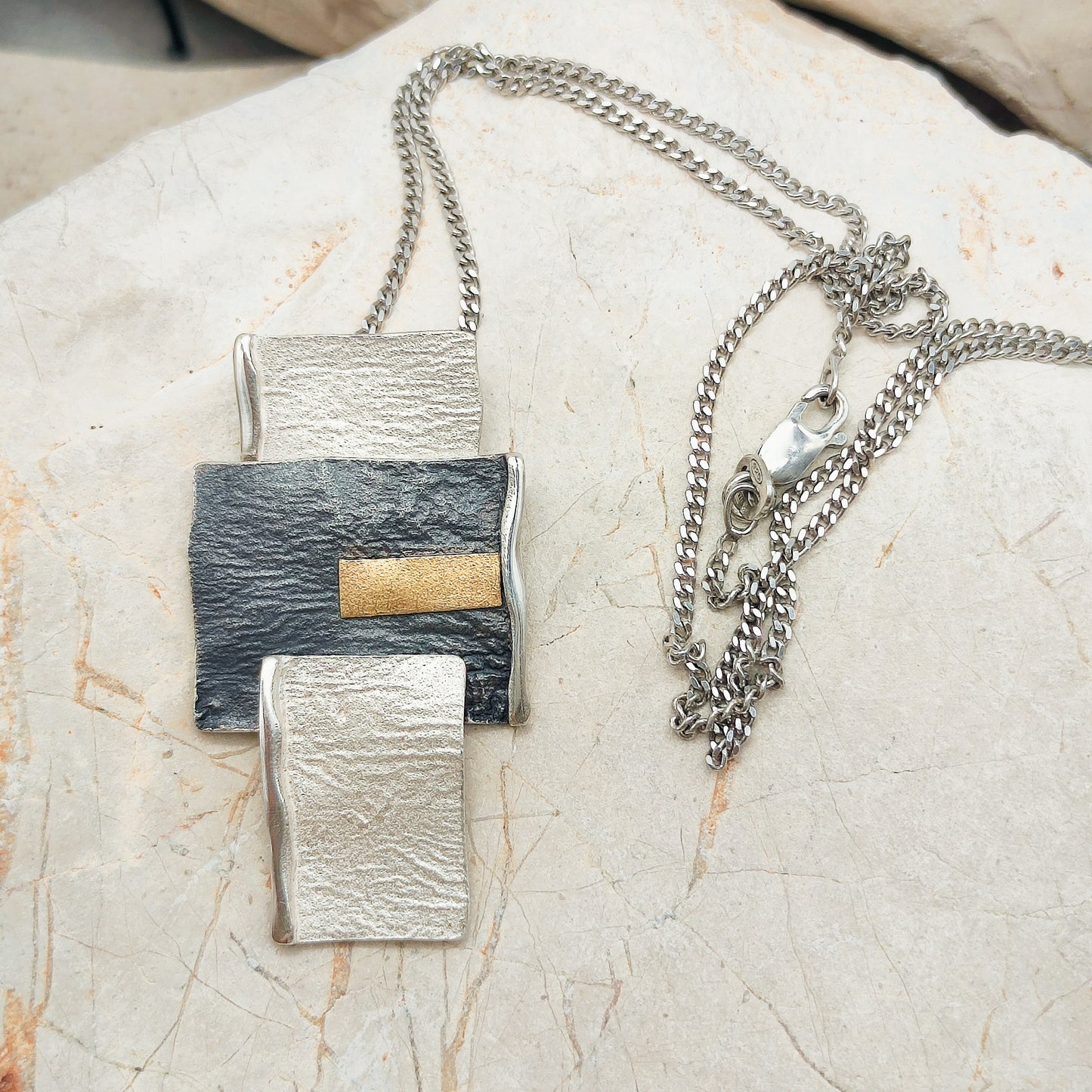 Handmade pendant by Audar in silver with 24K gold details