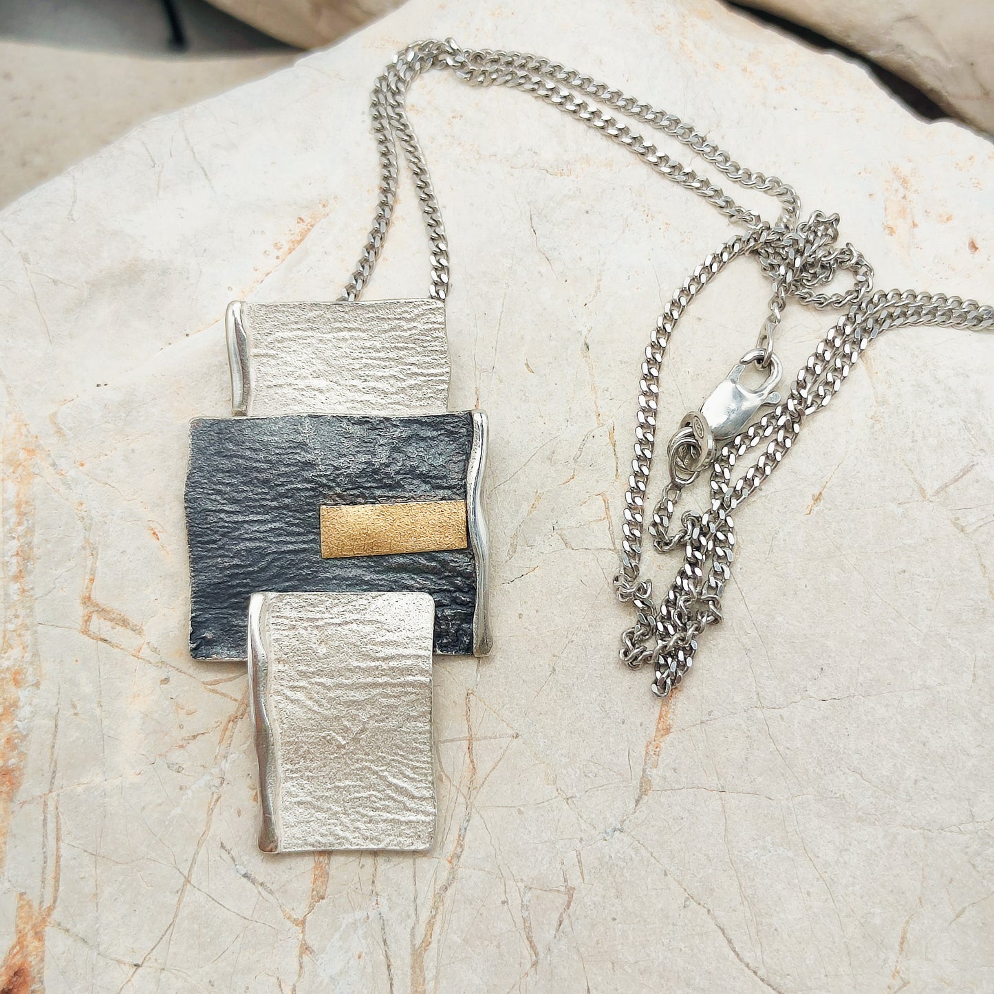 Handmade pendant by Audar in silver with 24K gold details