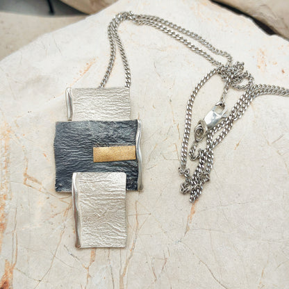 Handmade pendant by Audar in silver with 24K gold details