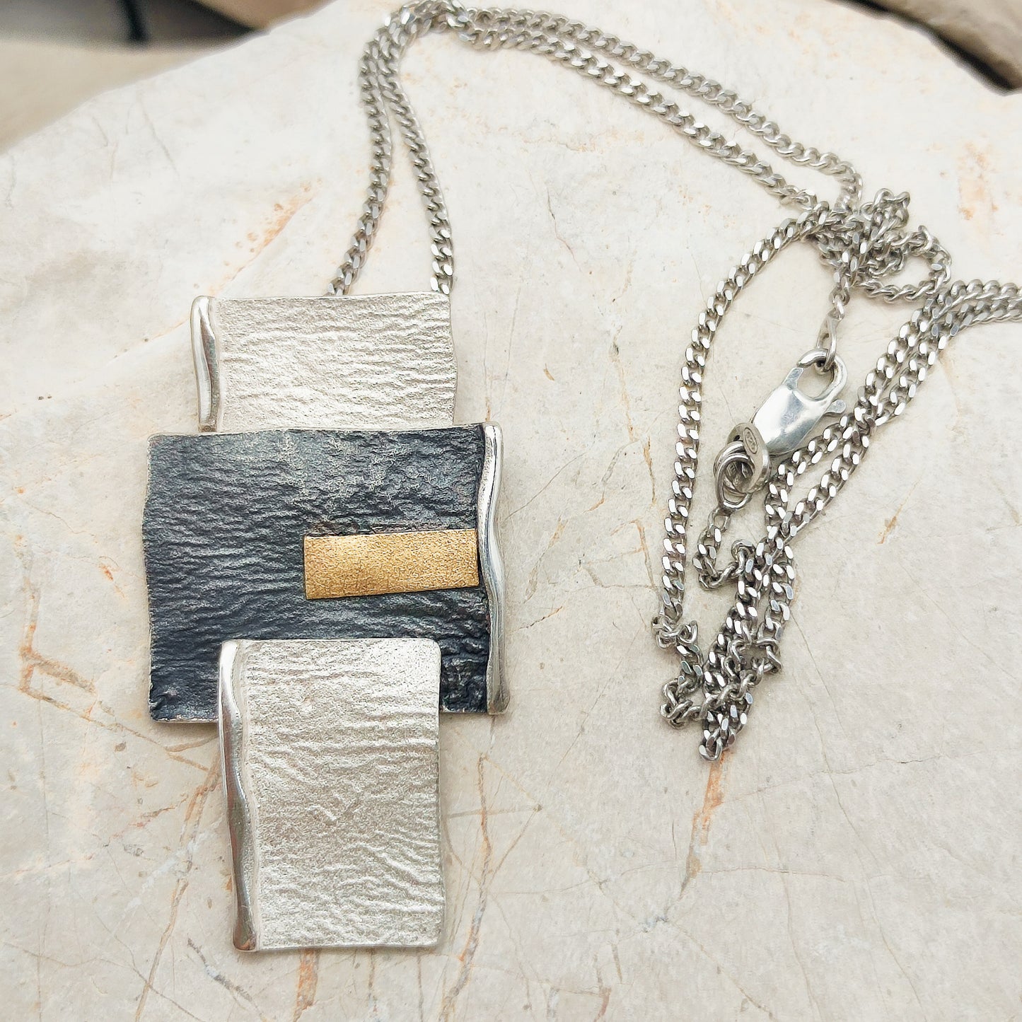 Handmade pendant by Audar in silver with 24K gold details