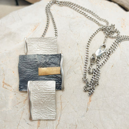 Handmade pendant by Audar in silver with 24K gold details