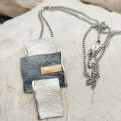 Handmade pendant by Audar in silver with 24K gold details