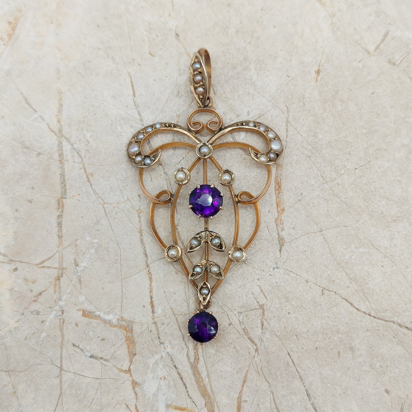 Antique Edwardian gold lavaliere pendant with seed pearls and amethyst centre stone.