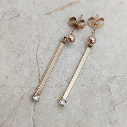 Close-up van vintage 9ct gouden bar drop oorbellen met diamant