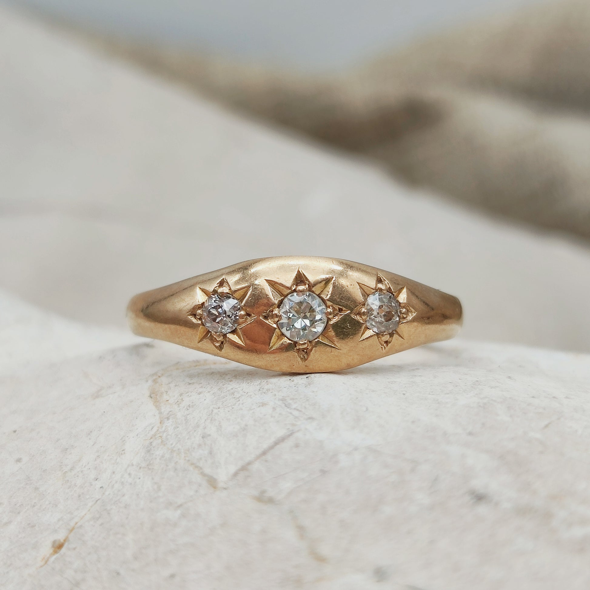 close-up vintage flush set diamond ring in rose gold