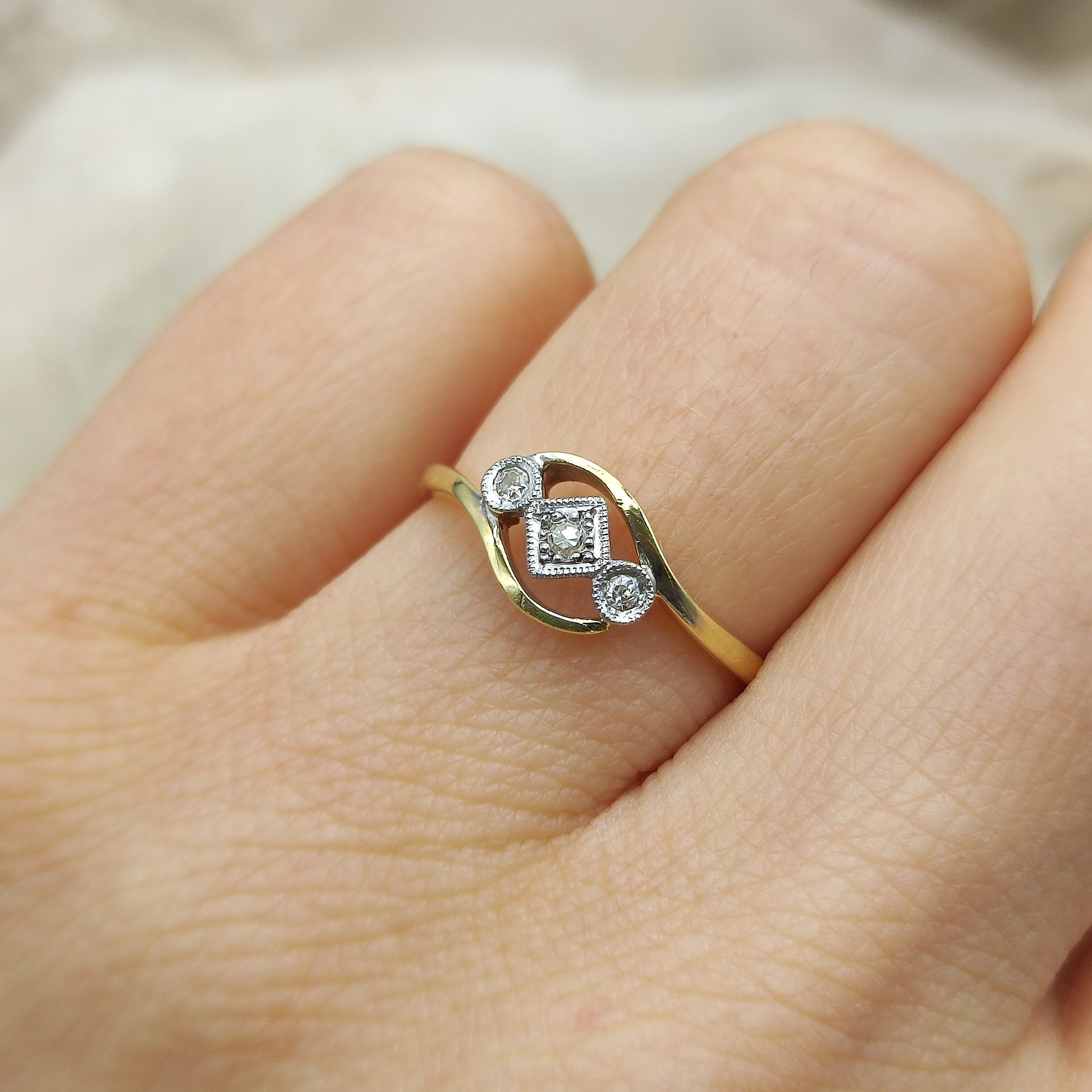 Edwardian crossover diamond ring worn on hand