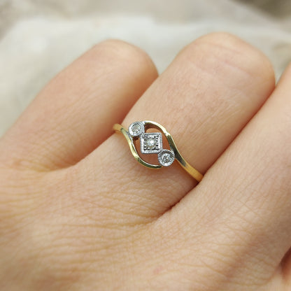 Edwardian crossover diamond ring worn on hand