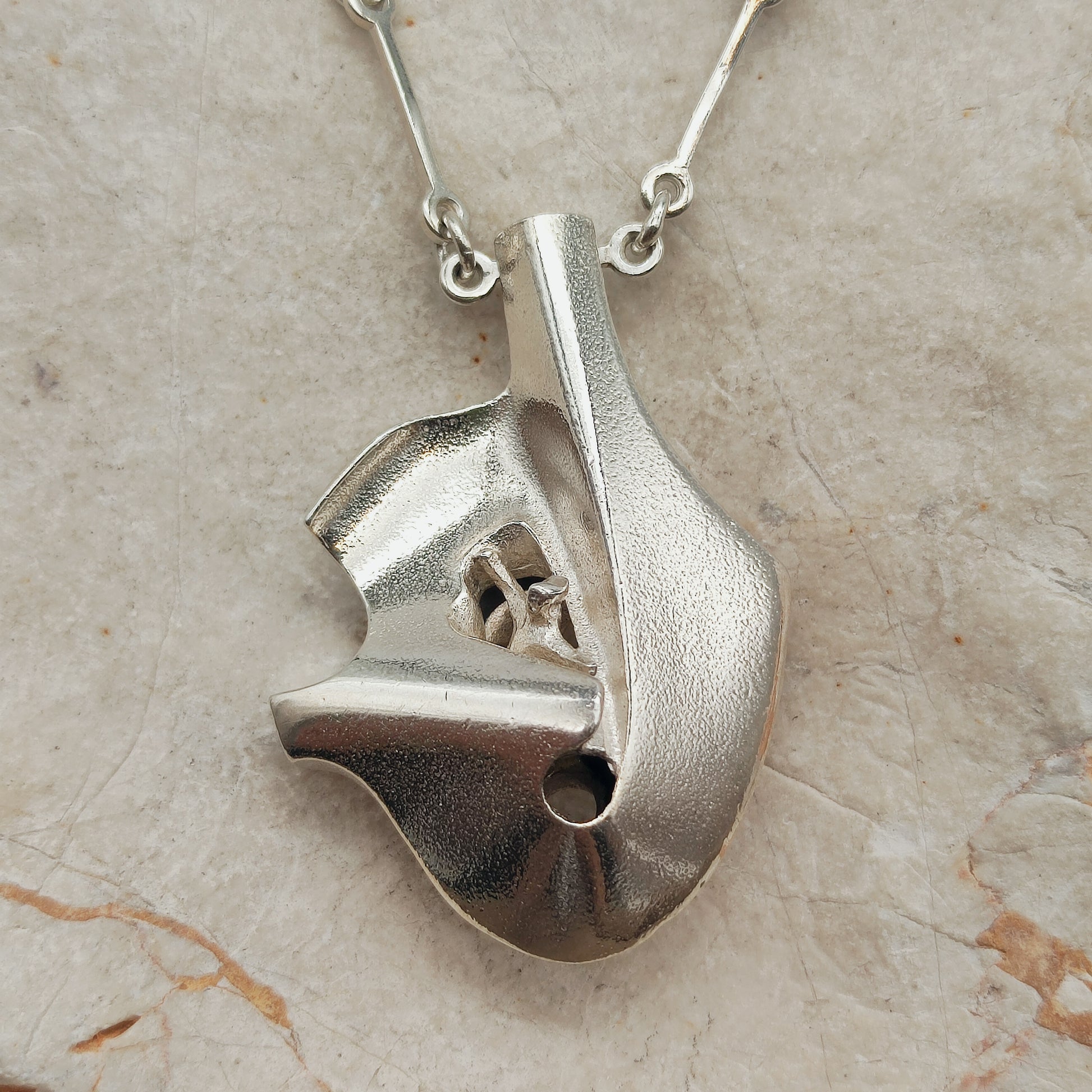 Sculptural Auriga pendant, also known as Man in the Crater