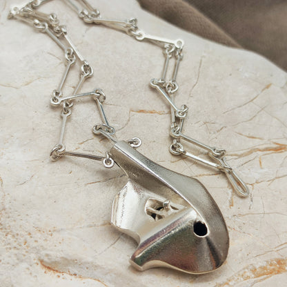 Side view of the three-dimensional sterling silver Auriga pendant