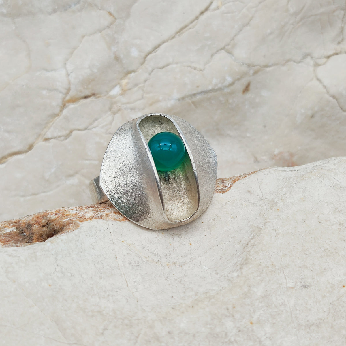 Vintage modernistische zilveren ring uit 1973 van Matti J. Hyvärinen met gematteerde bovenkant en beweeglijke groene bol.