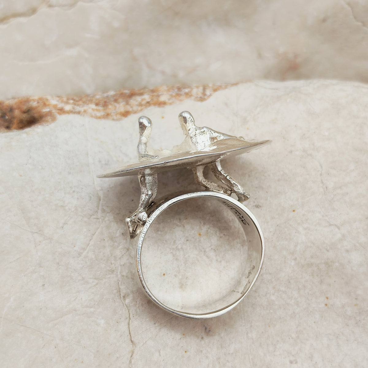 Vintage Galactic Dance-ring van Lapponia uit 1971, ontworpen door Björn Weckström, met twee dansende figuren op een gematteerde zilveren plaat.